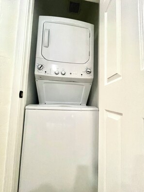 A compact washer and dryer unit in a small laundry room. - Serenity Casita-Bakersfield (Bakersfield)