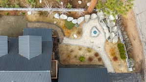 A house with a sloped roof, a stone pathway, and a small garden with rocks and plants. - 3BR Home steps from Lakeside Beach and Casinos (South Lake Tahoe)