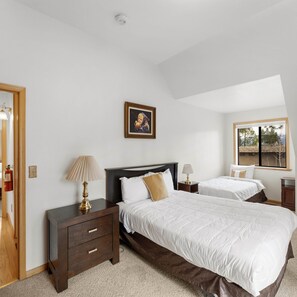 A hotel room with two beds, a painting, a window, and a door. - Alpine Escape (South Lake Tahoe)