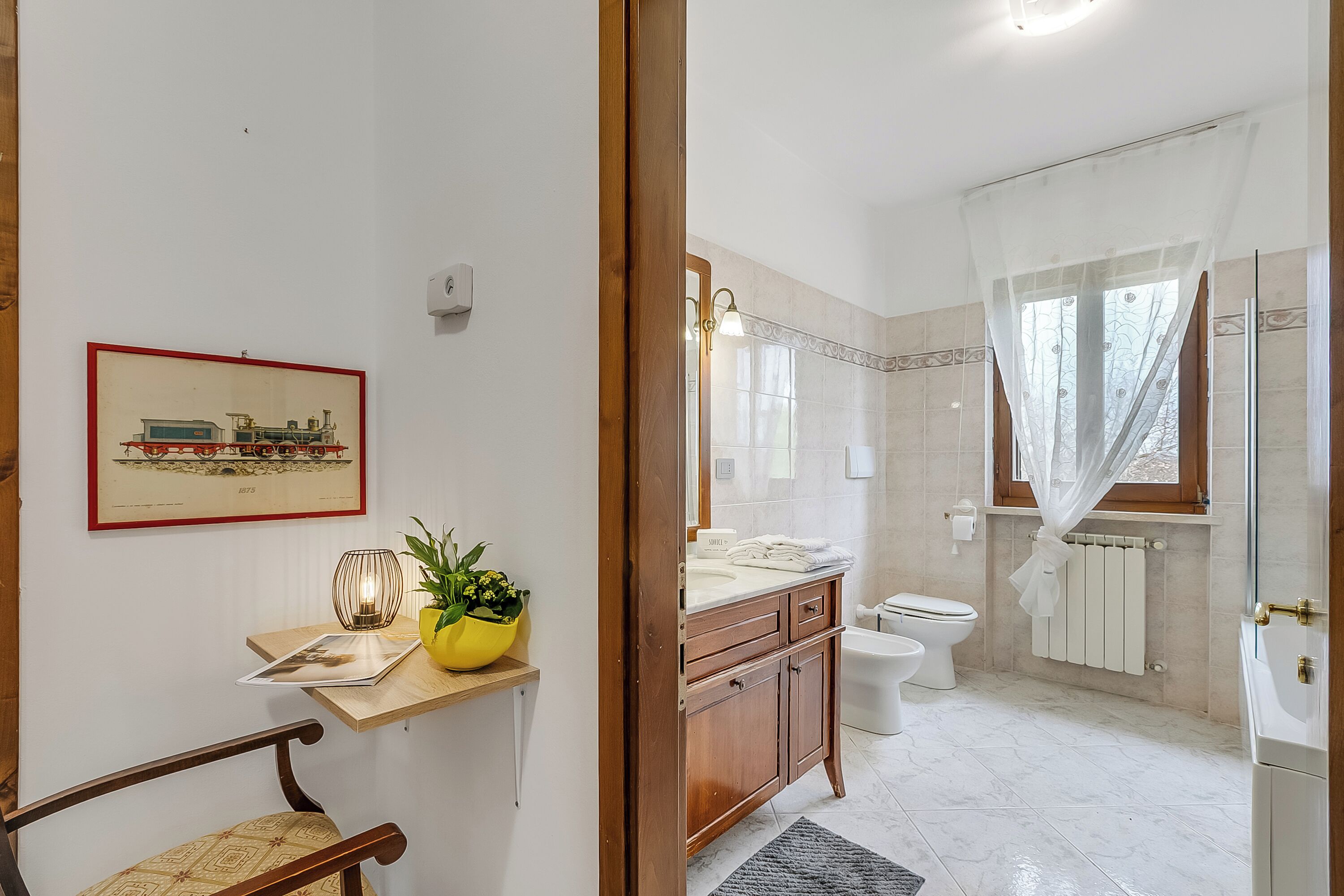 A bathroom with a toilet, sink, and shower area.