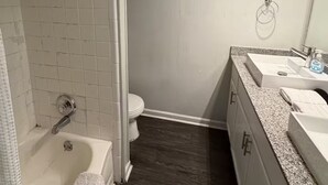 A bathroom with a shower, toilet, and sink. - Radiant 2x1 apt by West Campus UT! (Austin)