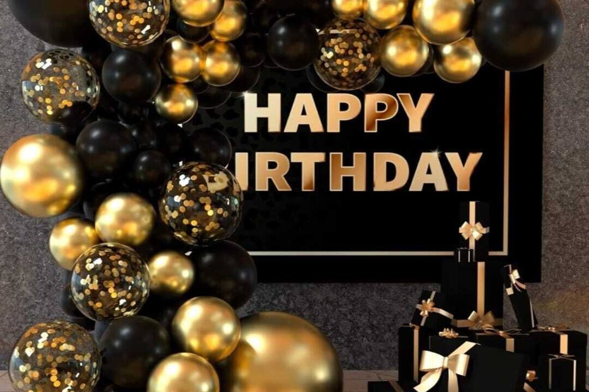 A black and gold birthday decoration with a 'HAPPY BIRTHDAY' sign.