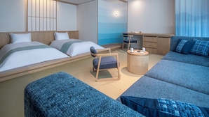 A hotel room with two beds, a sofa, a chair, a small table, and a wall with a view. - Hoshino Resorts KAI Miyajima (Hatsukaichi)