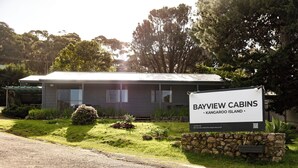 A cabin with a signboard indicating 'Bayview Cabins' located on Kangaroo Island.