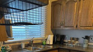 A kitchen with a granite countertop, wooden cabinets, a stainless steel sink, and a window with blinds. - 3 bedroom main level home away from Home! Pet friendly with fenced backyard! (Grande Prairie)