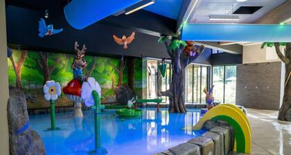 Cozy home in a holiday park with a swimming pool