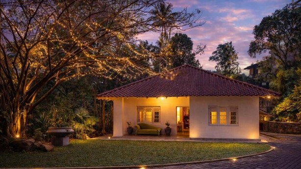 A house with a tiled roof, a lawn, and a paved driveway. - Heuvel Villa Kandy (Kandy)