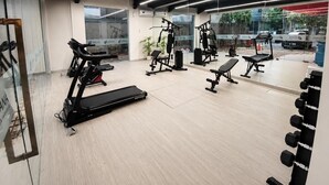 A gym with exercise equipment, a treadmill, and a mirror. - Asyana Pemuda Jakarta (Jakarta)