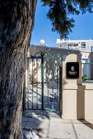 A gated entrance with a stone pathway leading to a building.