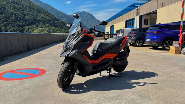 A motorcycle parked in a designated parking area with a mountain backdrop. - Pisogne, Authentic Mountain Retreat near Lake Iseo - Unique Bathroom (Pisogne)