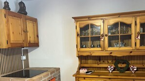 A kitchen with a brick oven, wooden cabinets, and a tiled floor. - Pisogne, Authentic Mountain Retreat near Lake Iseo - Unique Bathroom (Pisogne)