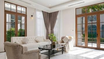 Deluxe Villa, City View | Living room | 450-inch flat-screen TV with satellite channels