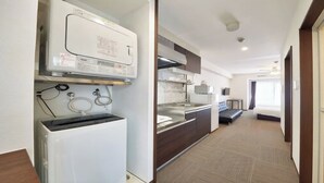 Hotellihuone, jossa on pieni keittiö, sänky, kylpyhuone ja näkymä ulos.