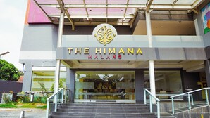 A building with a sign reading 'The Himana Malang' and a staircase leading to the entrance. - The Himana Hotel Malang (Malang)