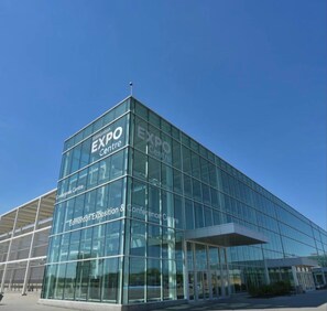 A modern glass building with 'EXPO Centre' signage, indicating a venue for exhibitions and conferences. - Gorgeous Beacon Heights 2 bedrooms apartment (Edmonton)