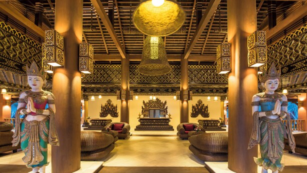 A traditional interior with ornate pillars, a central altar, and statues. - Royal Palace Hotel (Nyaung-U)