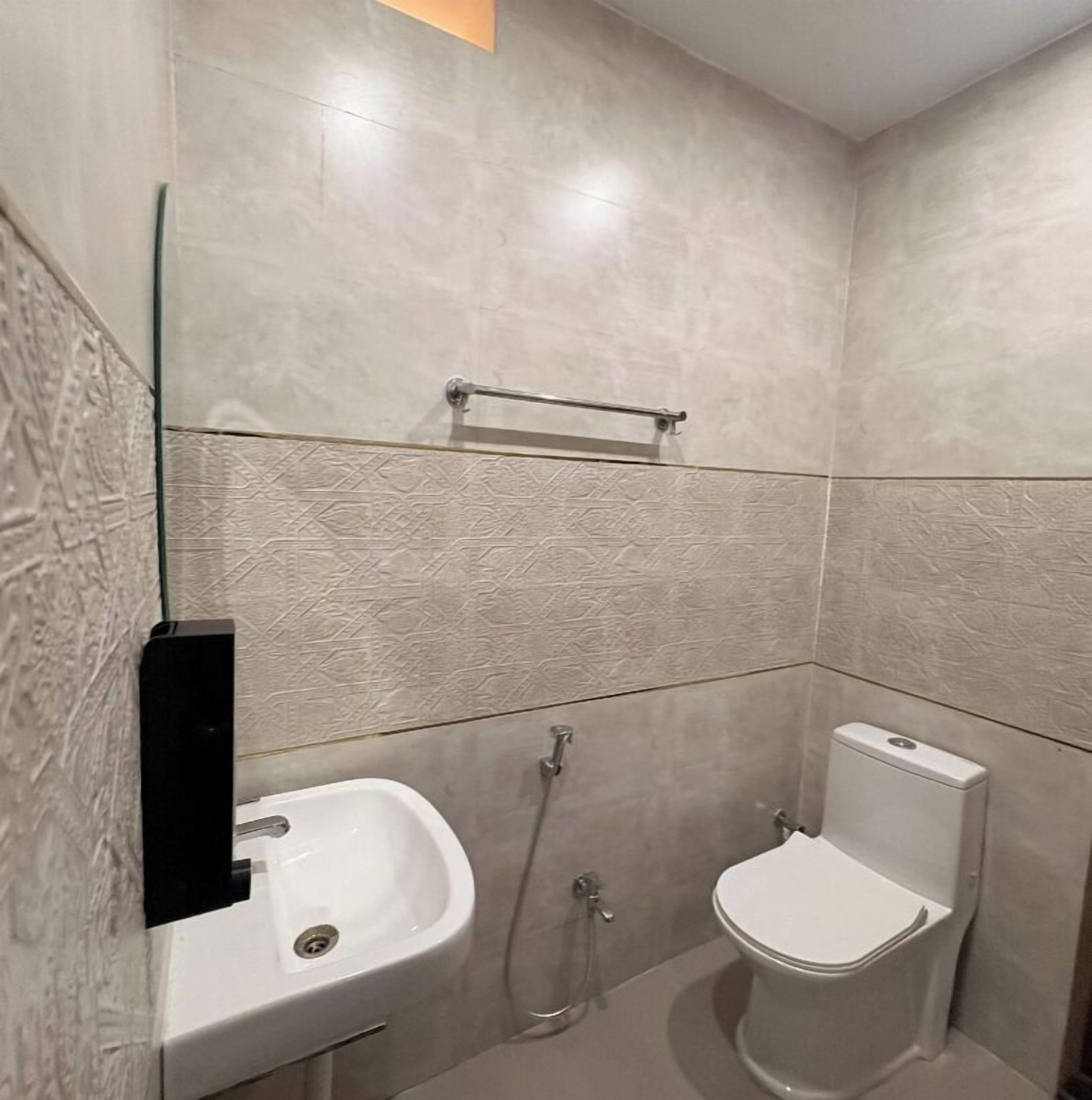 A bathroom with a sink, toilet, and shower.