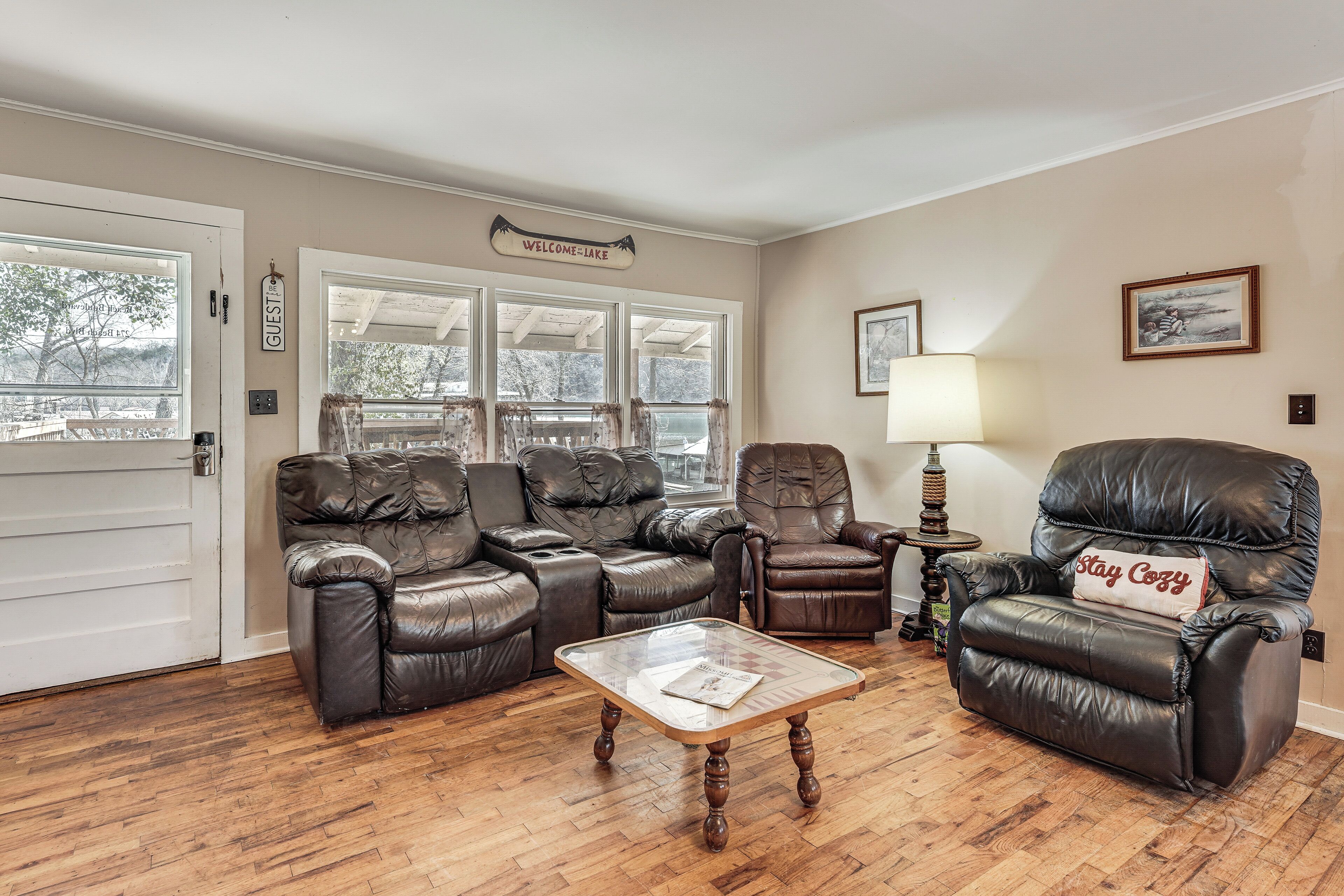 A living room with a sectional sofa, a recliner, a coffee table, and a lamp.