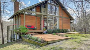 A modern house with a large deck, wooden siding, and a prominent chimney. - Fun w/ Family! Lakefront Gem in Jamestown (Jamestown)