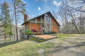 A modern house with a large deck, a chimney, and a view of the surrounding trees. - Fun w/ Family! Lakefront Gem in Jamestown (Jamestown)