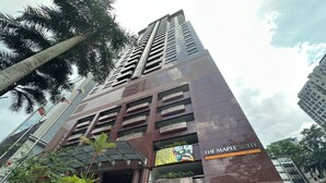 A tall building with a sign for 'The Maple Suite.' - The Maple Suite by Manhattan (Kuala Lumpur)