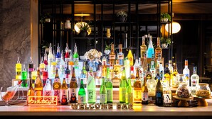 A bar area with a variety of liquor bottles and a 'WELCOME' sign. - SUPER HOTEL Kirishima Natural Hot Spring (Kirishima)