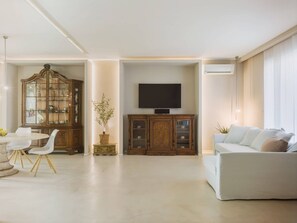 A living room with a dining area, a television, and a sofa. - Villa / Independent home in Lido Di Camaiore with 4 bedrooms sleeps 8 (Lido Di Camaiore)