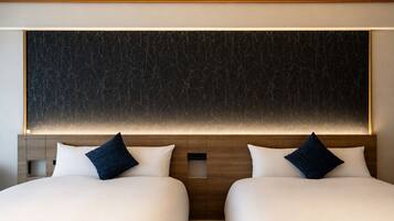 Ein Hotelzimmer mit zwei Betten, einer großen, dunkel strukturierten Wand und einem Holzkopfstück.