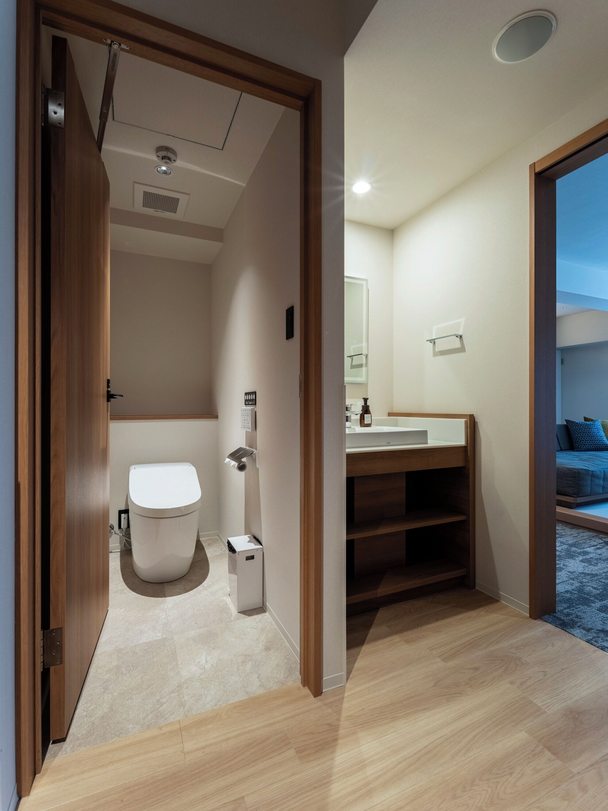 A modern bathroom with a toilet, sink, and shower area.