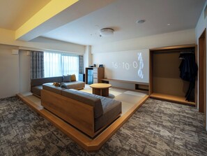 A modern living room with a sofa, a coffee table, and a wardrobe.