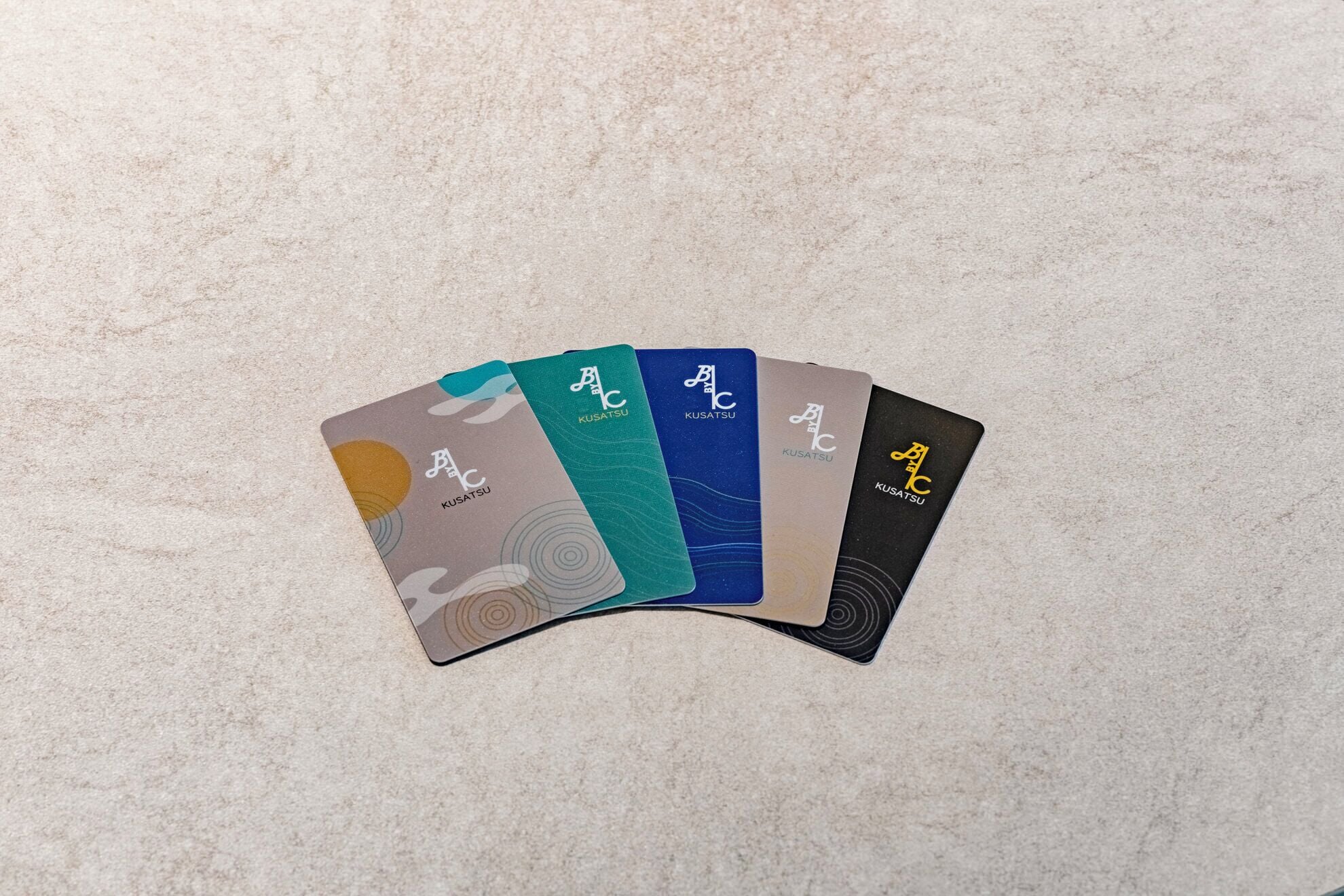 A set of cards with the 'Kusatsu' logo on a textured surface.