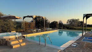 A swimming pool with lounge chairs and a pergola. - Podere Novo (Bibbona)