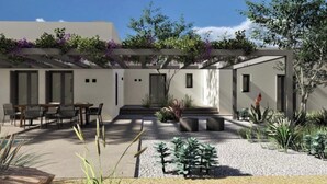 A modern house with a patio, outdoor seating, and a variety of plants. - Villa Lemoni – Walk to the Beach (4798+R23 Xifara, Greece)