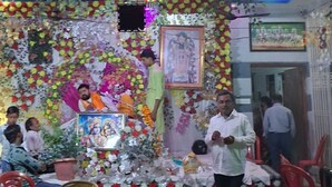 A hotel interior with a decorated stage, seating, and a visible AC room sign. - Gopalkunj Homestay (Faizabad)