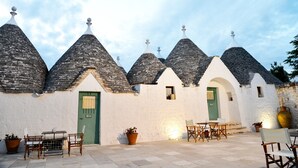 A building with conical roofs and a green door.