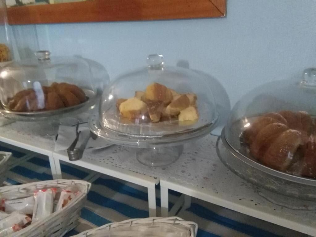 A buffet setup with covered food displays.
