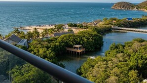 A coastal view with a beach, a pier, and a small island with a dock. - Ocean view + Direct beach view in Pozos colorados (Urb Plenomar)
