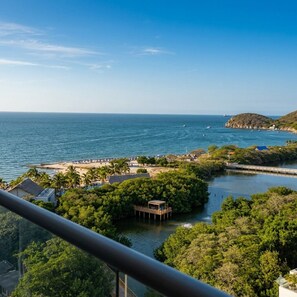 A coastal view with a beach, a pier, and a small island with a dock. - Ocean view + Direct beach view in Pozos colorados (Urb Plenomar)