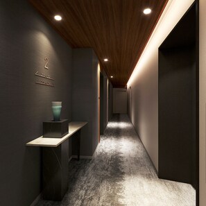 A hallway with a wooden ceiling, a dark floor, and a wall-mounted number sign. - Premium MONday OSAKA SHINSAIBASHI (Osaka)