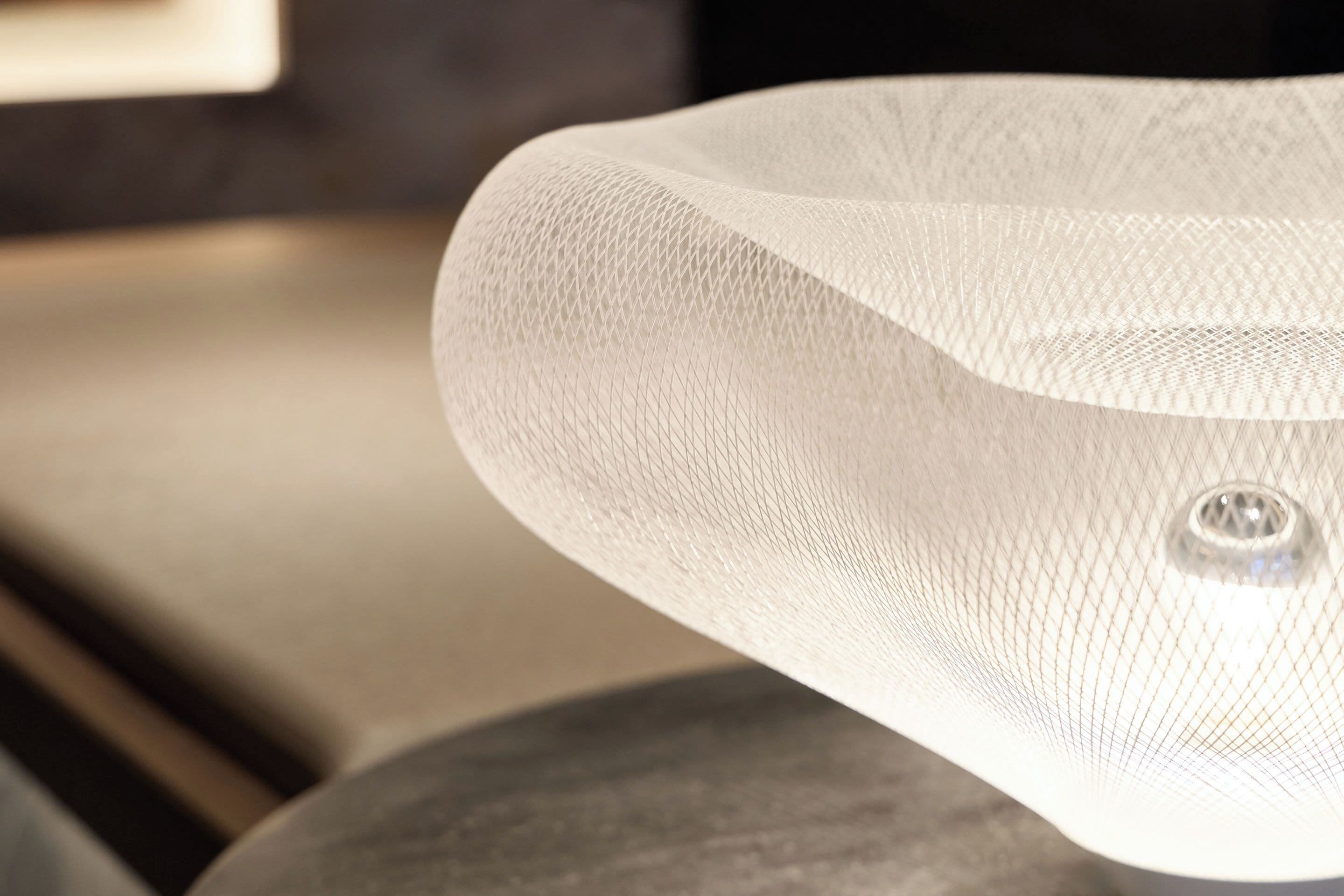A close-up of a textured, translucent object with a central circular feature, possibly a light fixture or decorative element.