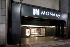 A modern building with a prominent 'MONday' sign above the entrance. - Premium MONday OSAKA SHINSAIBASHI (Osaka)