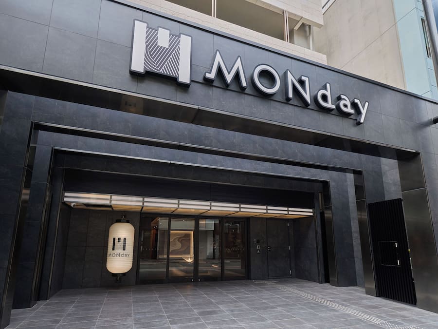 A modern building facade with a prominent 'MONday' sign above the entrance.