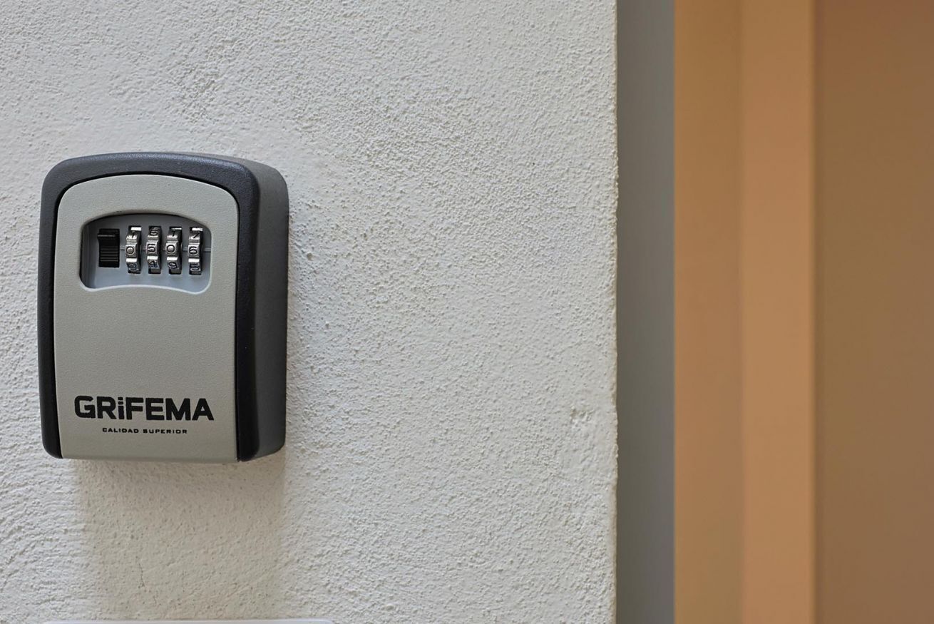 A wall-mounted security device labeled 'GRIFEMA' with a keypad.