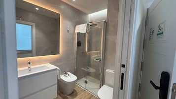 Appartement | Badkamer | Een douche, een haardroger, handdoeken, zeep