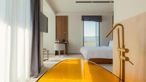 A hotel room with a bed, a desk, a chair, a TV, and a large window. - Hotel Meteo Kakheti (Telavi)