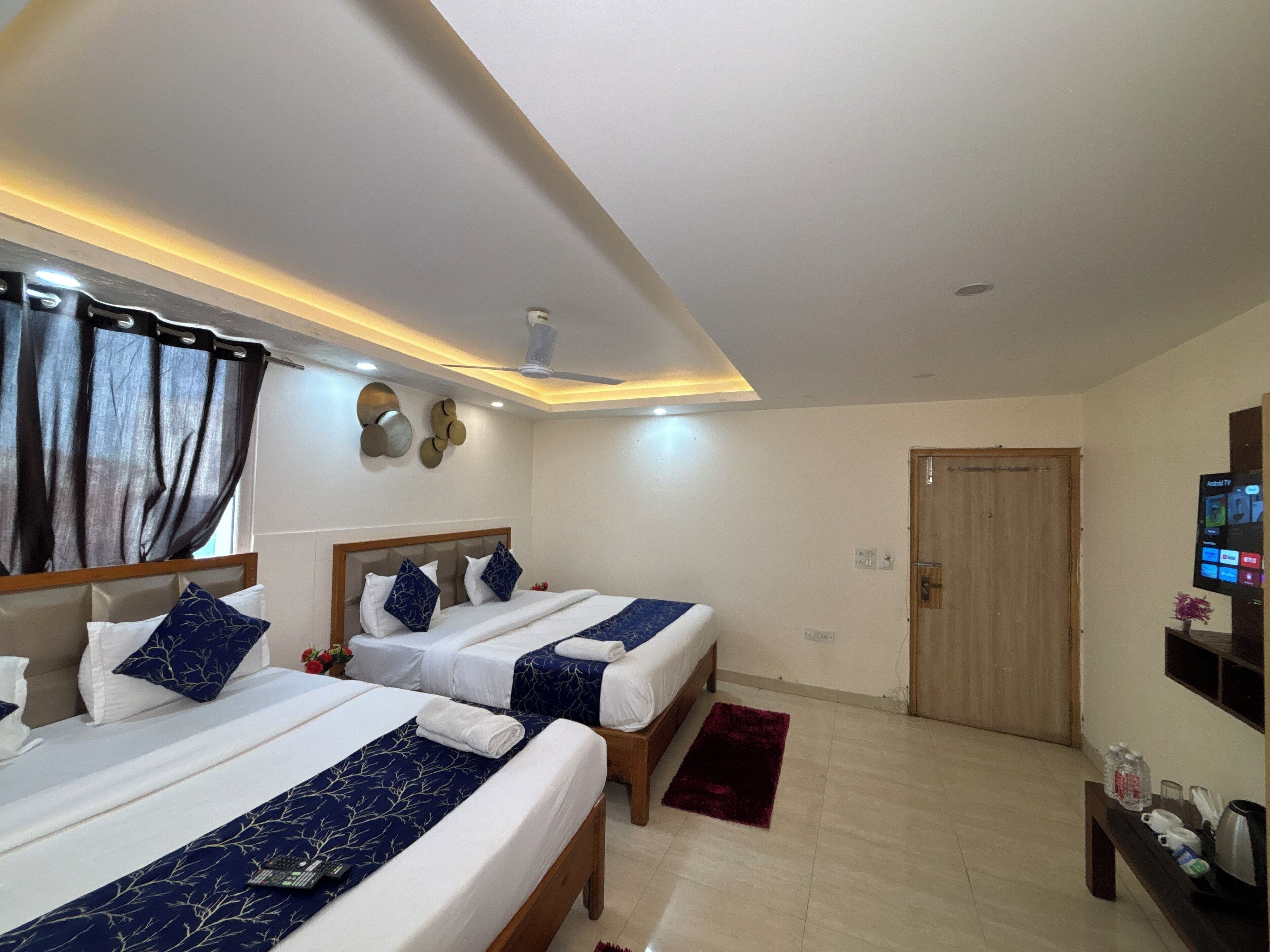 Deluxe Quadruple Room, Balcony, City View | In-room safe, desk, laptop workspace, blackout curtains