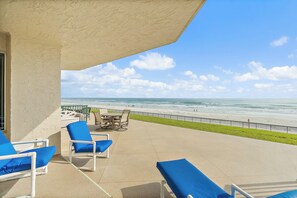 Terrace/patio - Enjoy this beachfront 2BR condo in Ponce Inlet with a ground-level patio offering direct access to pool and beach. Features a heated pool, fitness room, and clubhouse. Master has a king bed with private bath; guest room includes a king and two twins (Ponce Inlet)