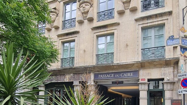 A historic building with ornate facades, multiple balconies, and a café entrance. - UrbanFlat 226 - Appartement pour 6  au Centre de paris (Paris)