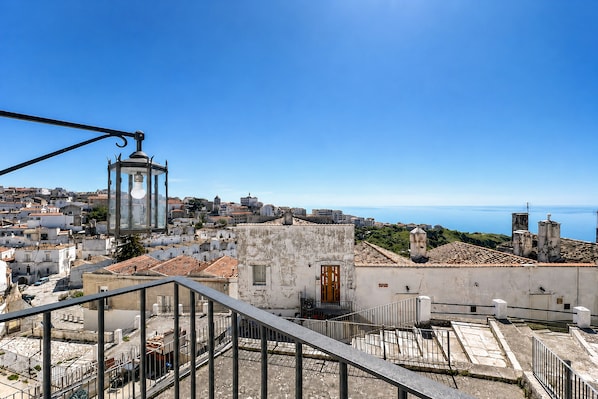 A cityscape with a clear view of buildings, a streetlight, and a staircase leading to a higher vantage point.