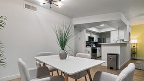 A modern kitchen with white cabinets, a microwave, and a sink. - Great for Mid/Long Stays - Pool - King Bed (Mesa)